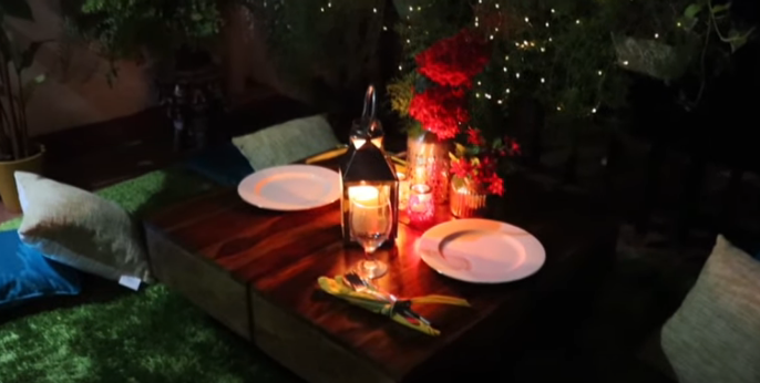 A table with plates and candles on it Description automatically generated with low confidence